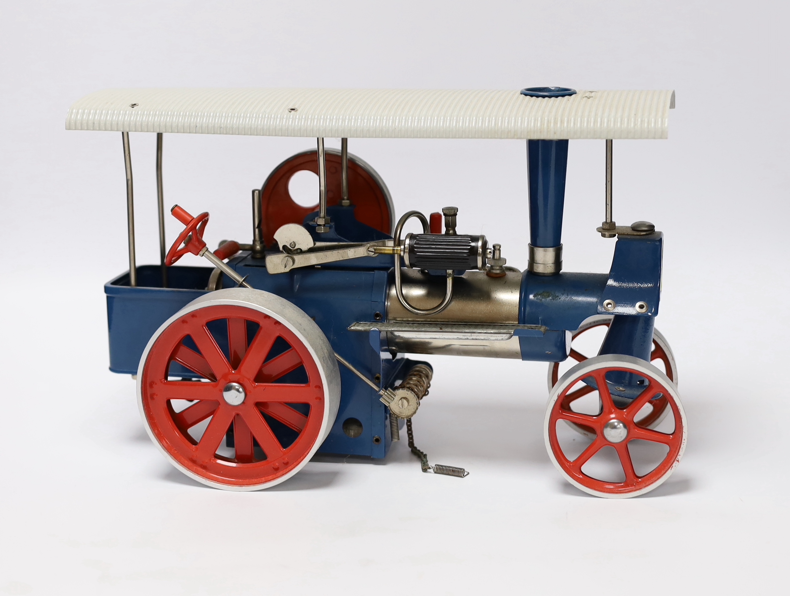 A boxed Wilesco ‘Old Smoky’ live steam traction engine (D40) and two accessories; a circular saw (M53) and a two-wheel grinder (M52), all boxed